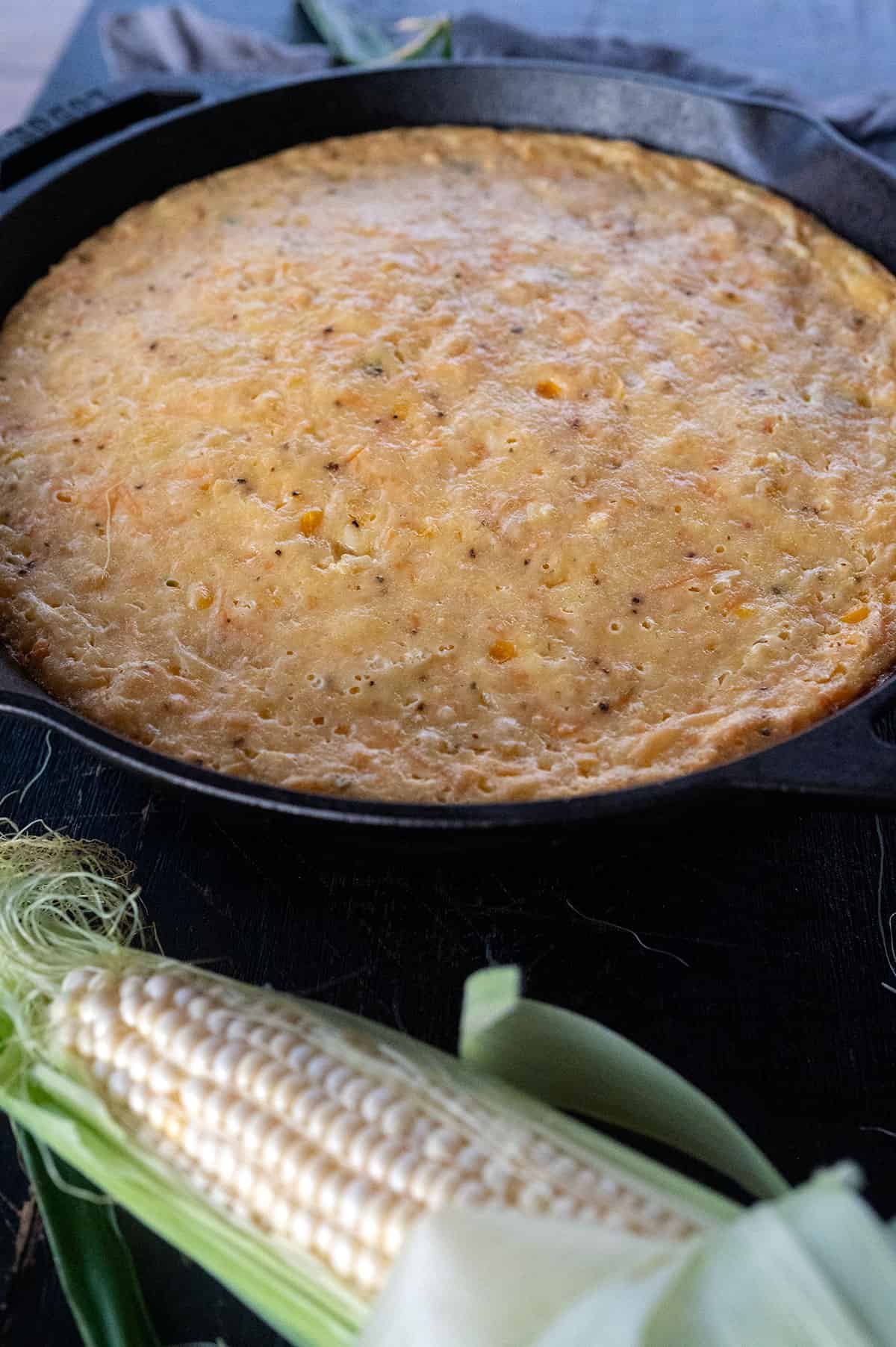 Smoked corn pudding casserole in skillet.