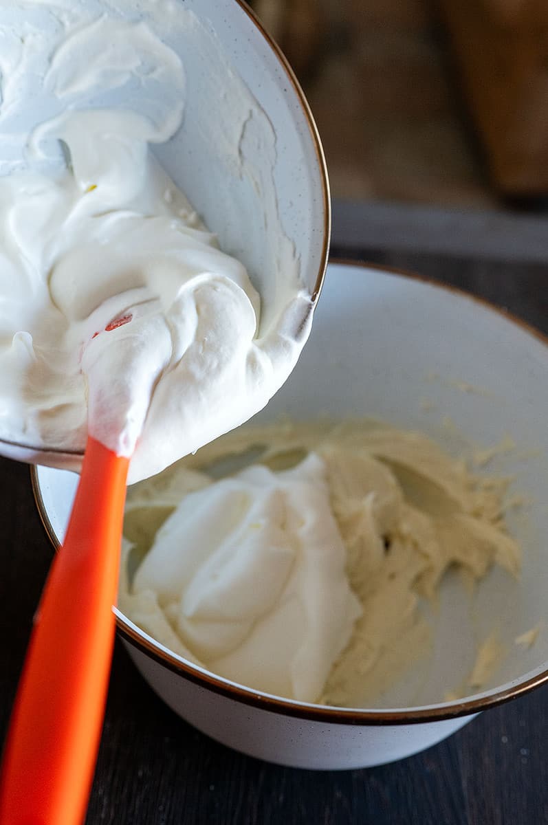 Folding heavy cream into mascarpone.