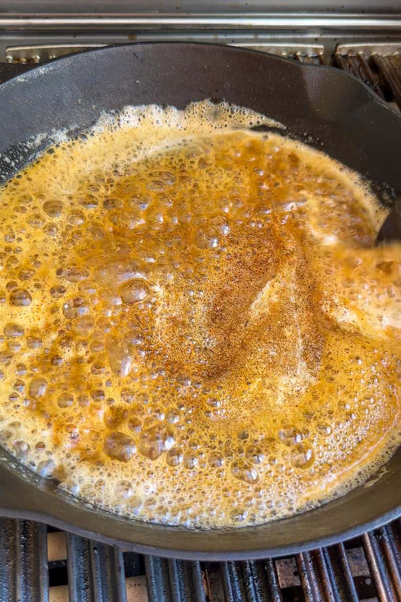 Memphis rub stirred into melted butter in a skillet.