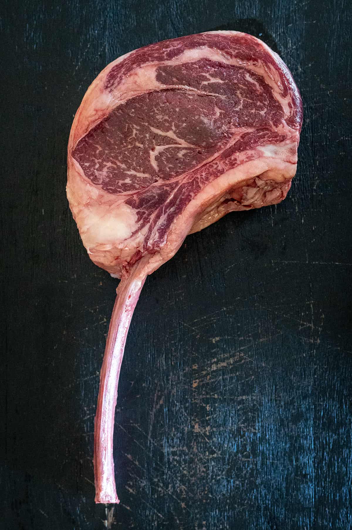 raw tomahawk steak.