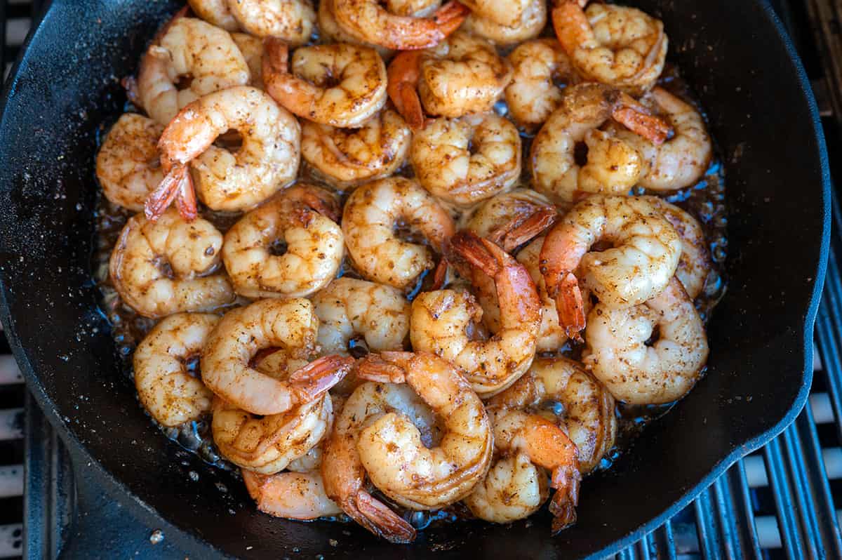 Fully cooked BBQ shrimp in skillet.
