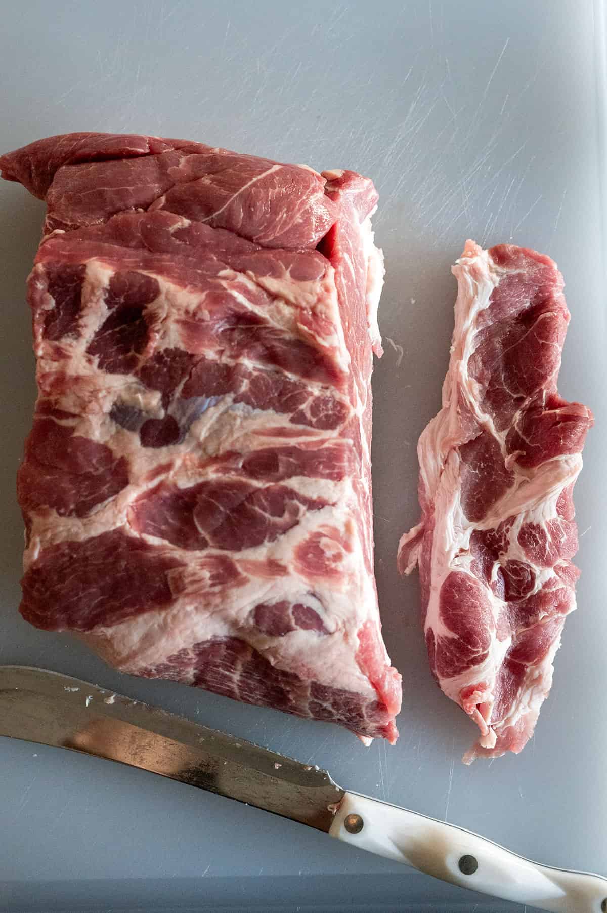 Pork steaks sliced from pork shoulder.