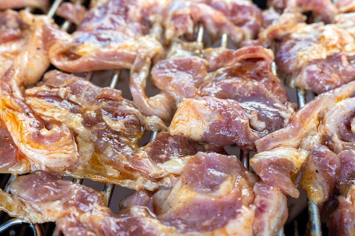 Pork tocino placed on grill in single layer.