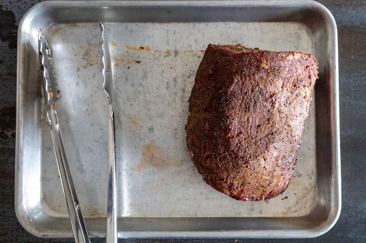 Smoked roast beef resting on pan. 