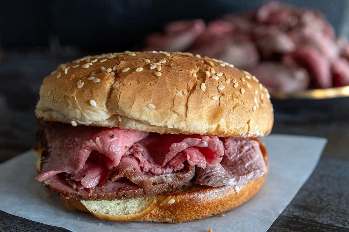 Thinly sliced roast beef on a toasted bun.