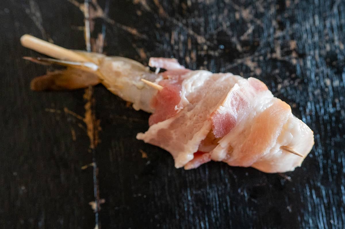toothpick securing bacon around shrimp.