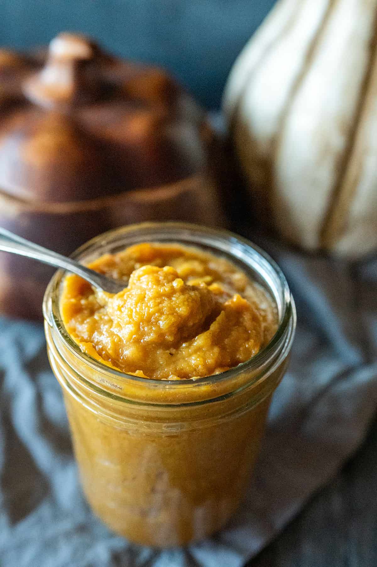 Spooning pumpkin butter from a jar.
