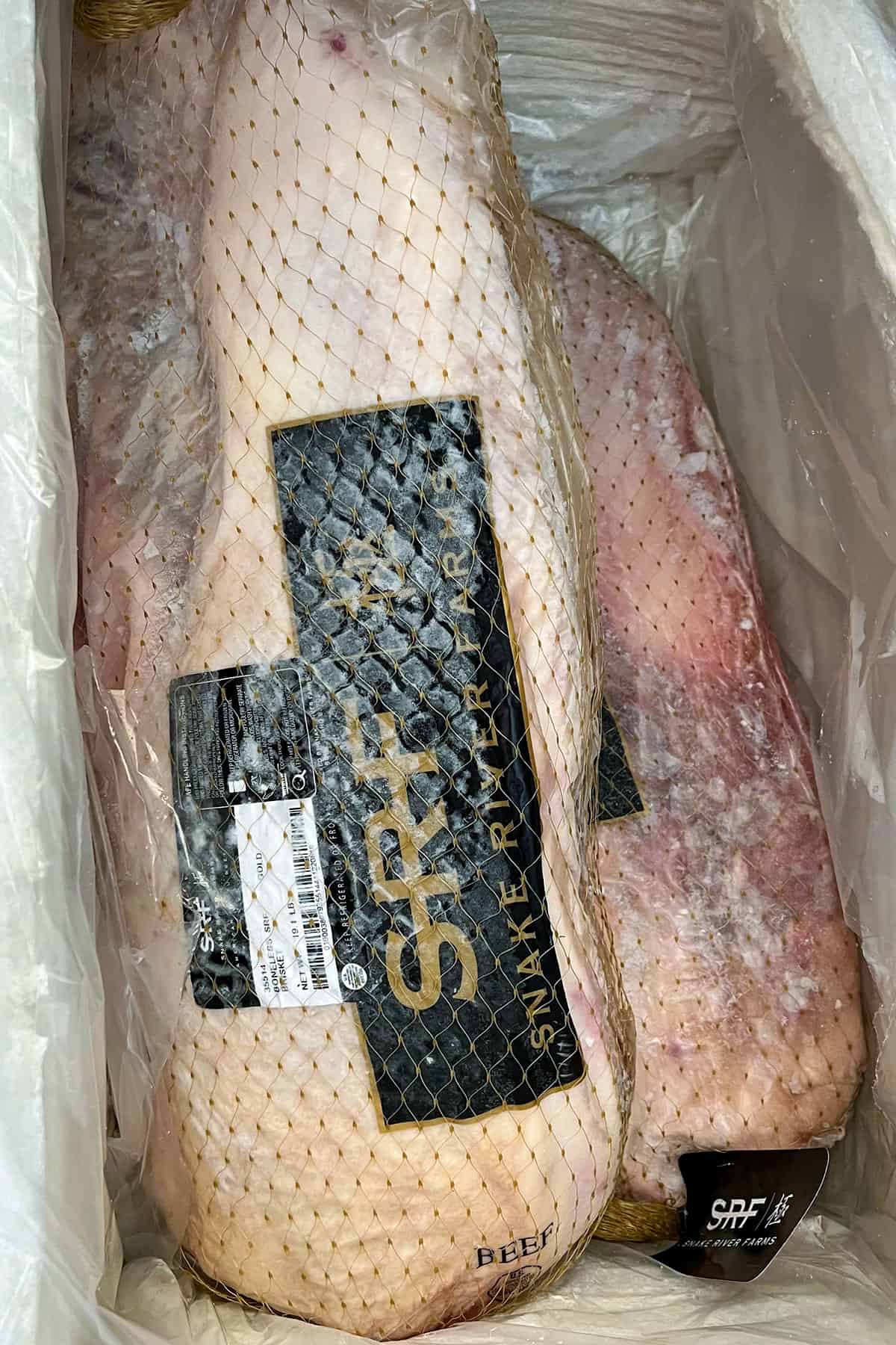 two frozen briskets delivered in a box.