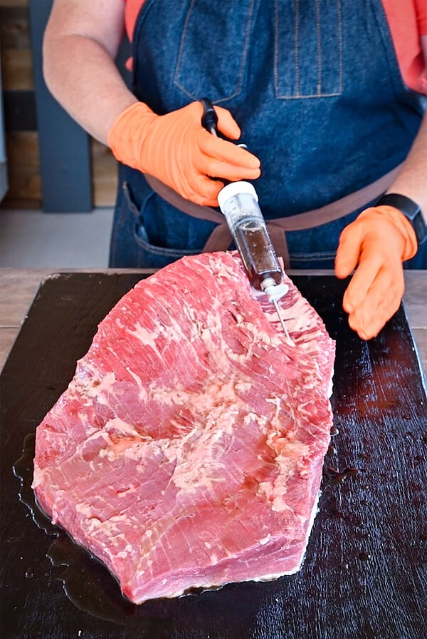 injecting a raw brisket.