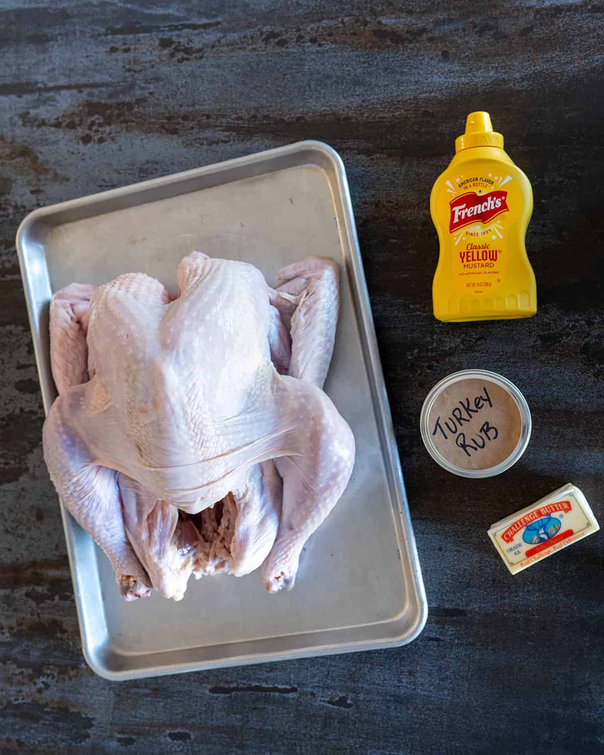 Whole fresh turkey, mustard, turkey rub and butter.