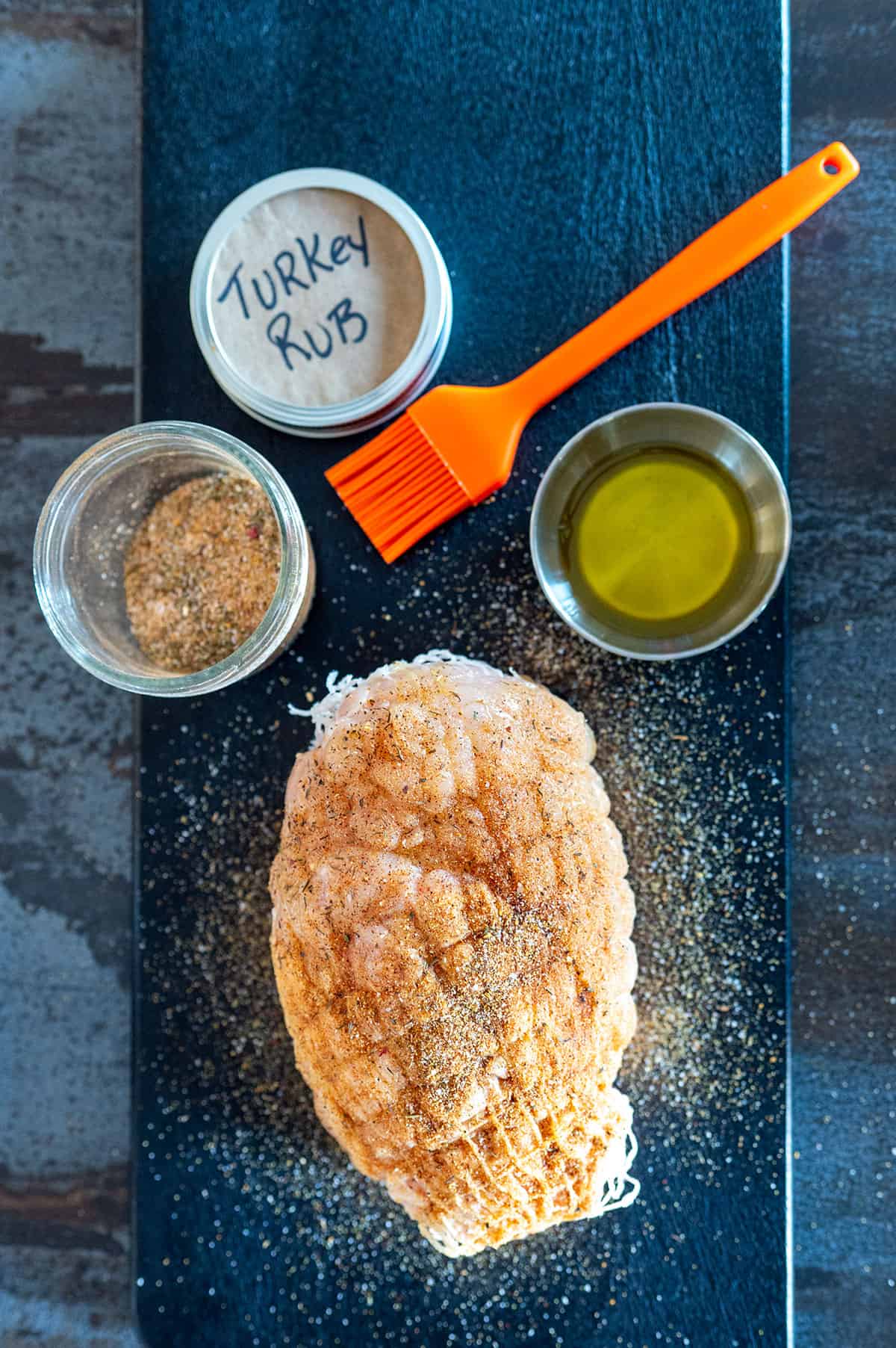 Turkey breast roast brushed with oil and seasoned with rub.