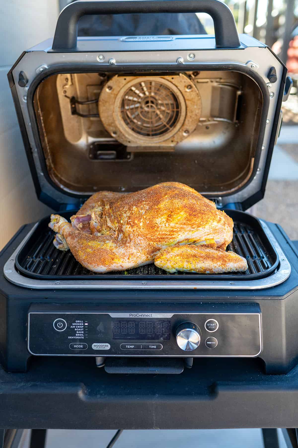 Seasoned whole turkey on Ninja Woodfire ProConnect XL Grill.