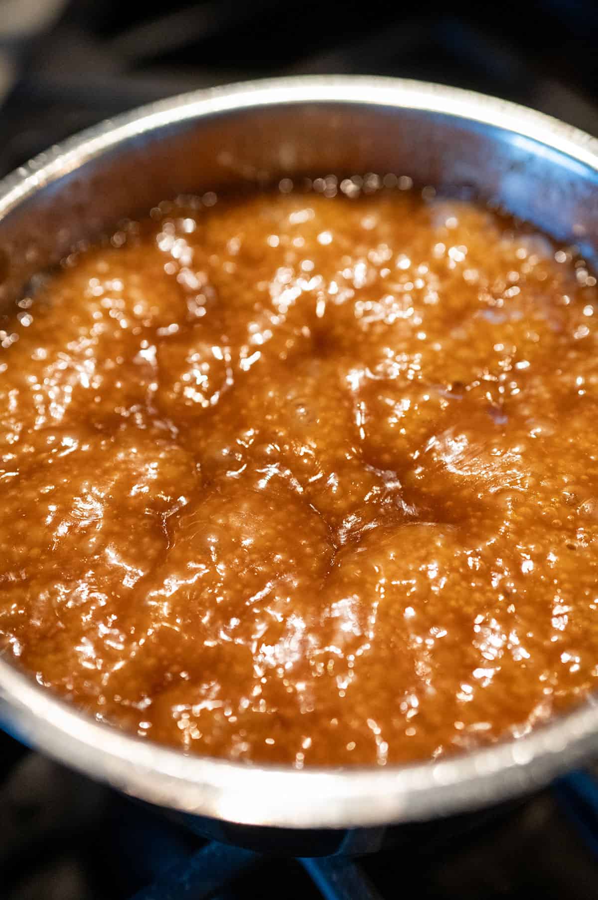 Brown sugar and butter boiling in pot.