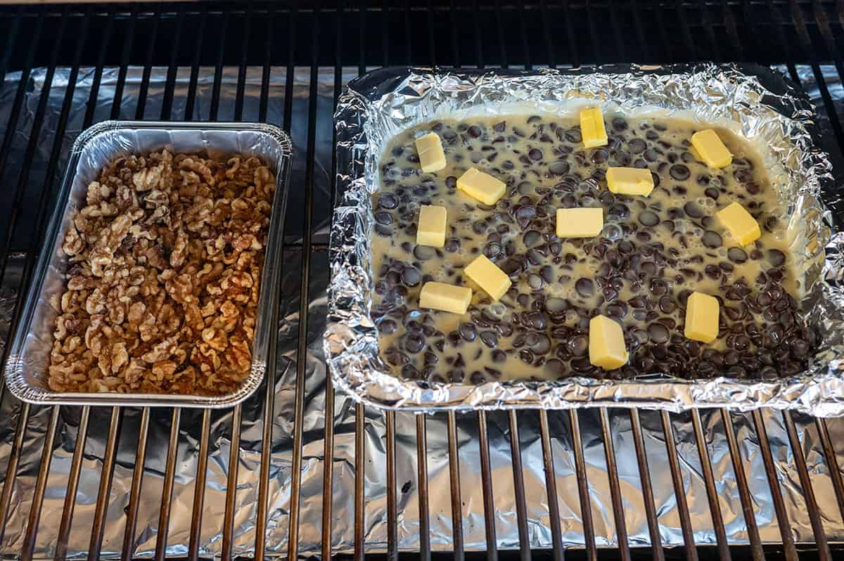 walnuts in pan on grill next to chocolate chips in pan on grill.
