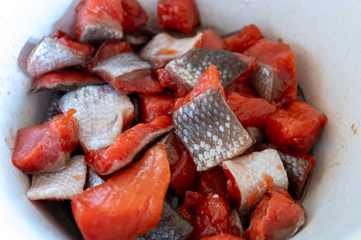 salmon cubes in bowl with brown sugar and salt.