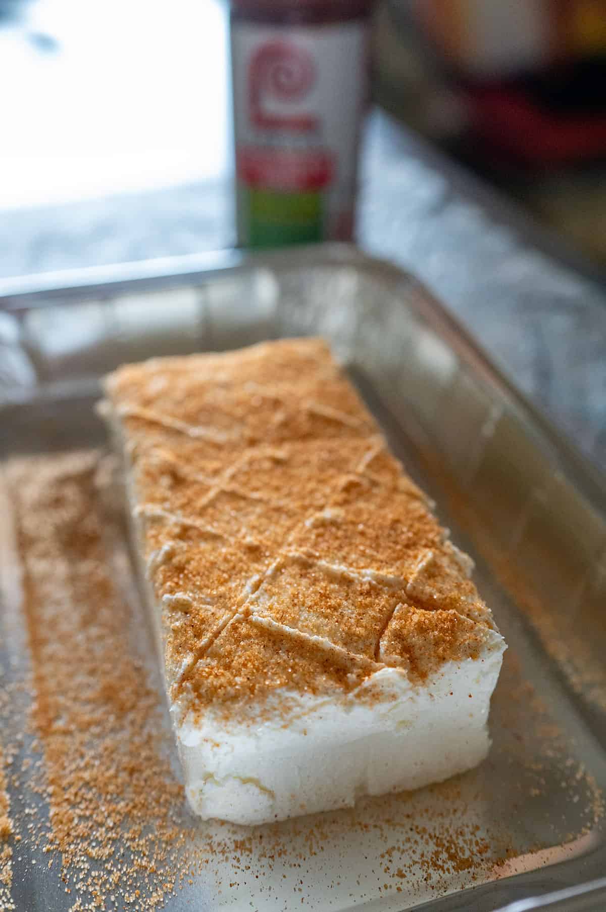 Cream cheese scored and topped with seasoning salt.