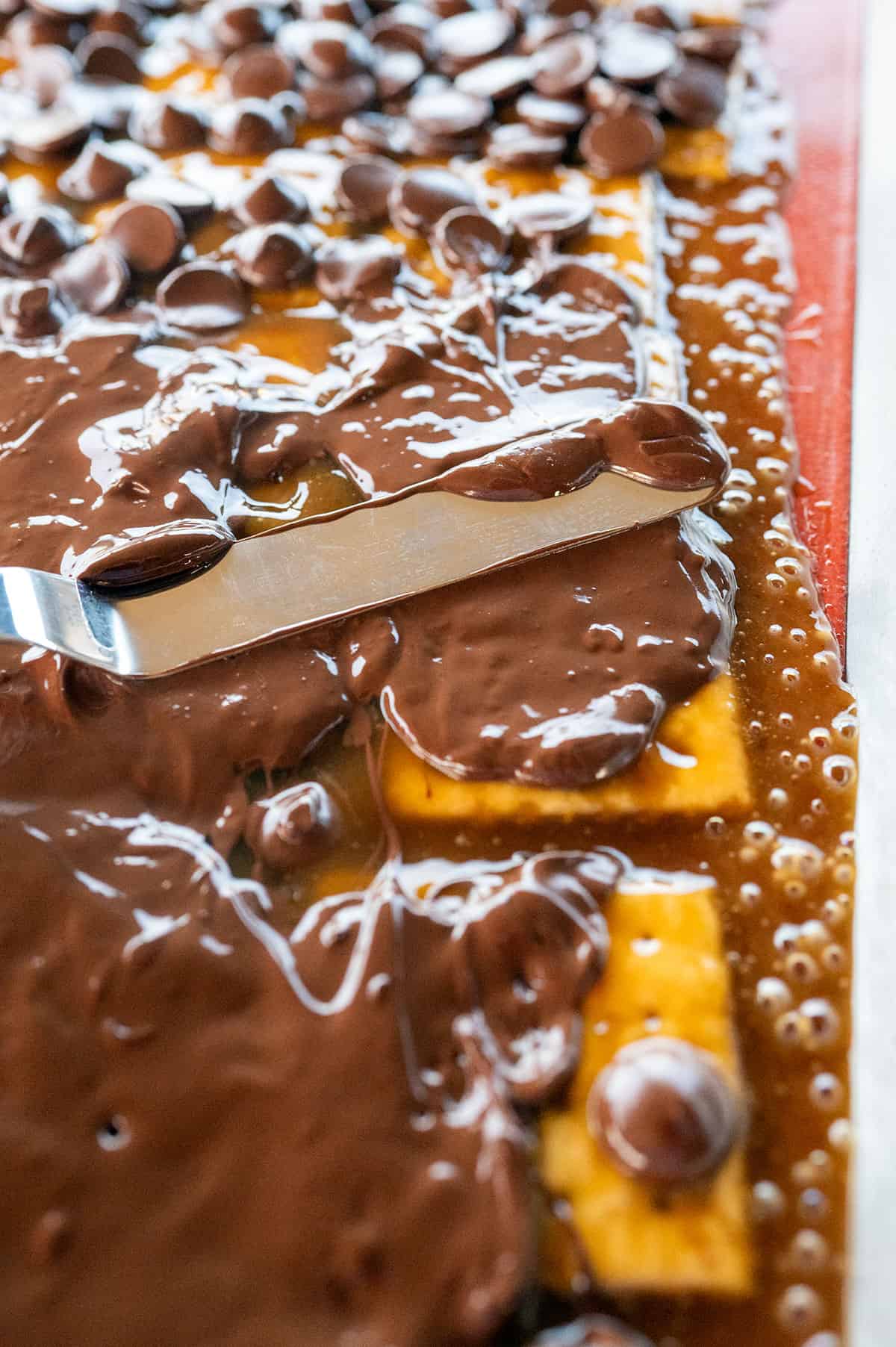 Spreading melted chocolate with an offset spatula.