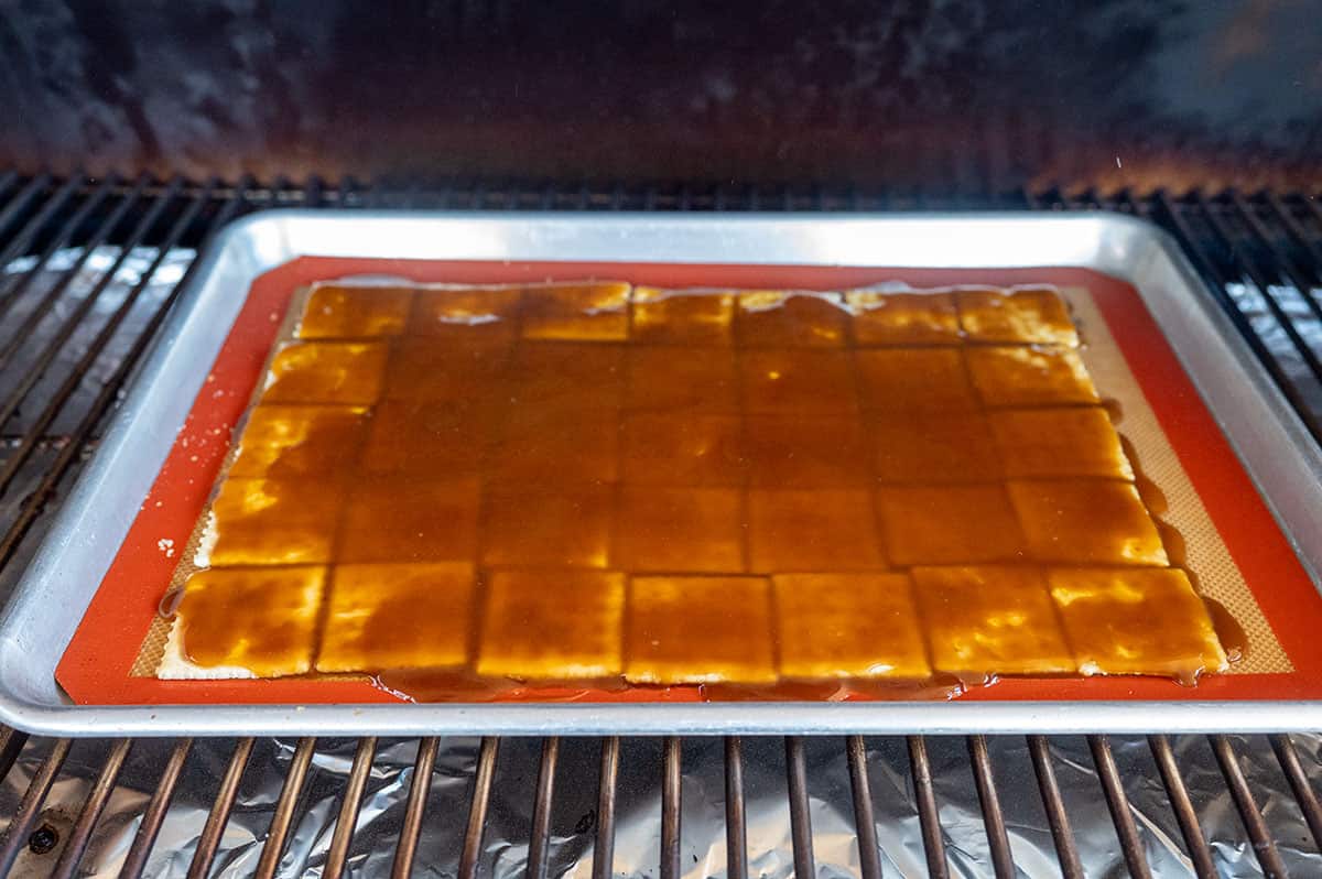 Pan of toffee covered crackers on pellet grill.