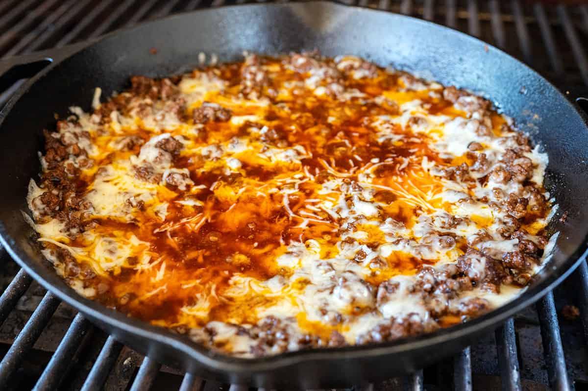 Melted cheese on skillet of ground beef.