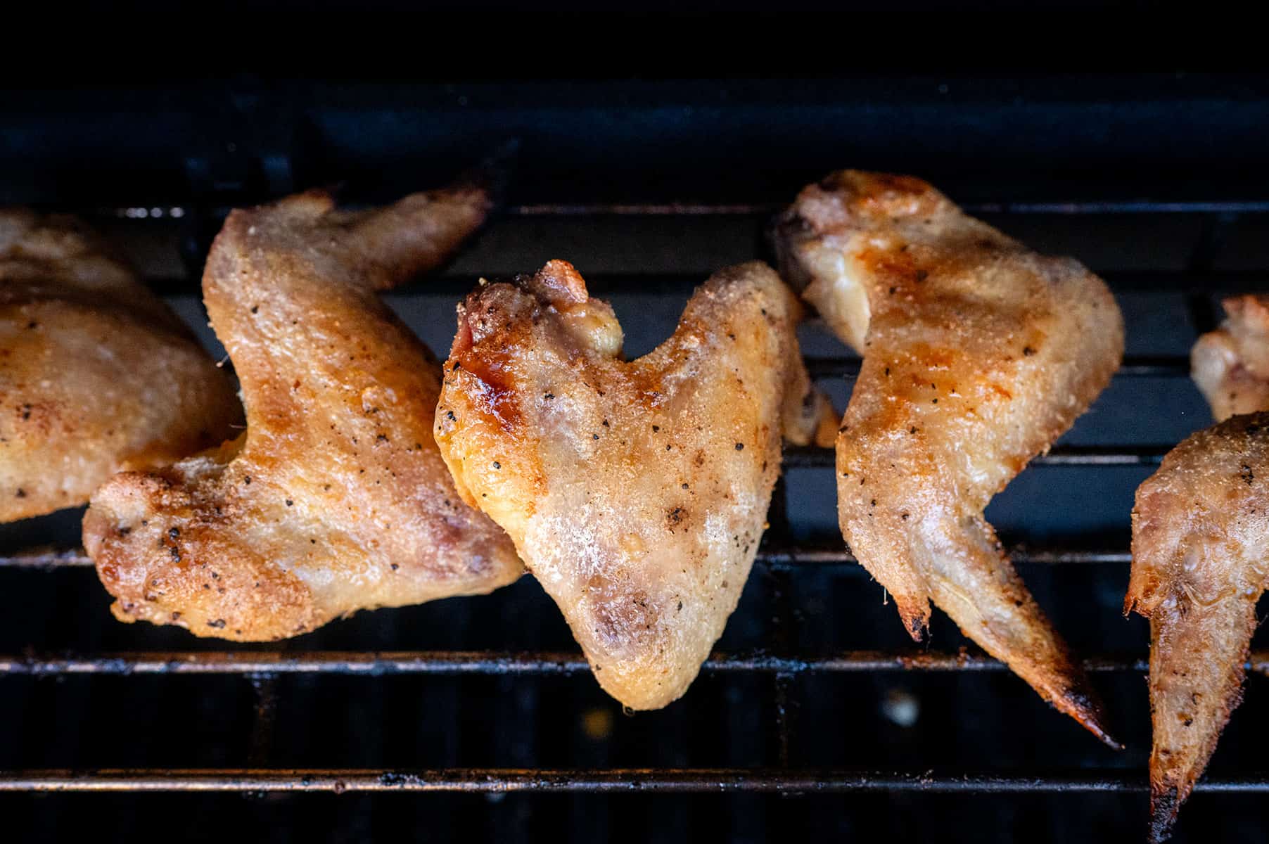 Crispy chicken wings on grill skin up.