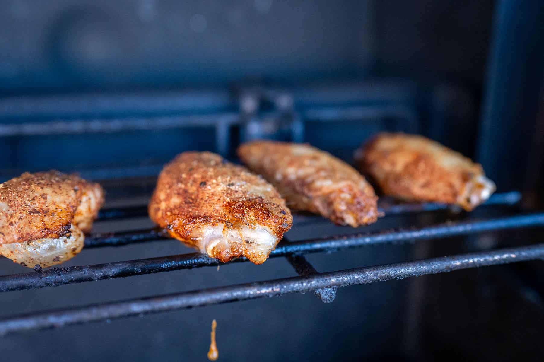 Chicken wing on gas grill.