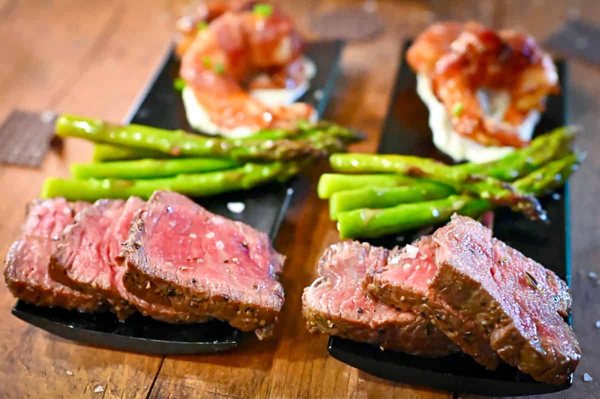 slices of filet mignon with asparagus and shrimp.