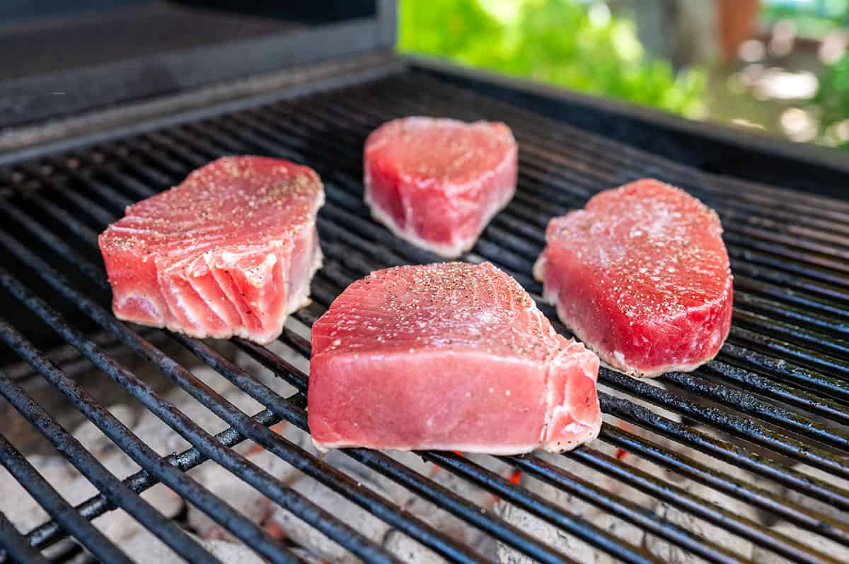 raw tuna steaks on a grill.