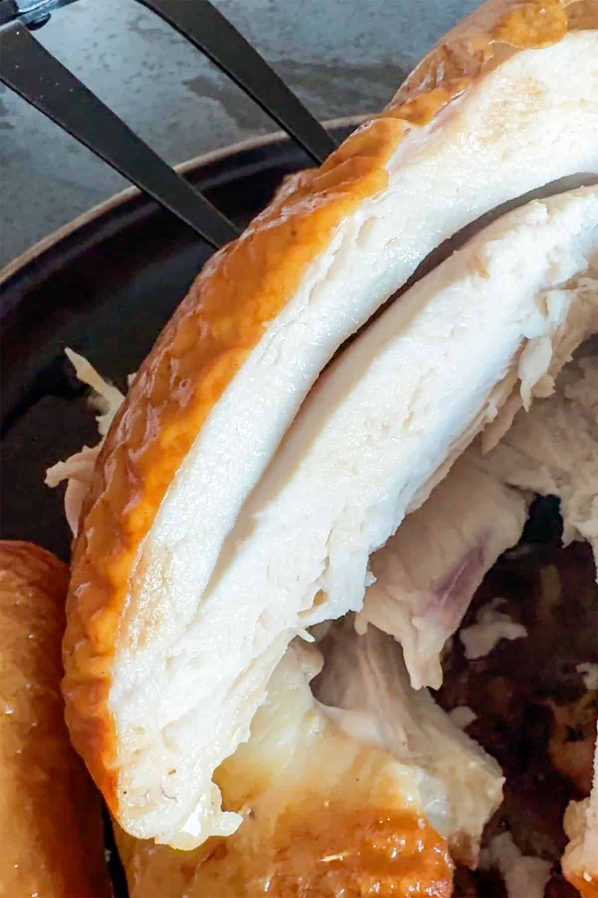 Sliced chicken breast from whole chicken smoked on indoor smoker.