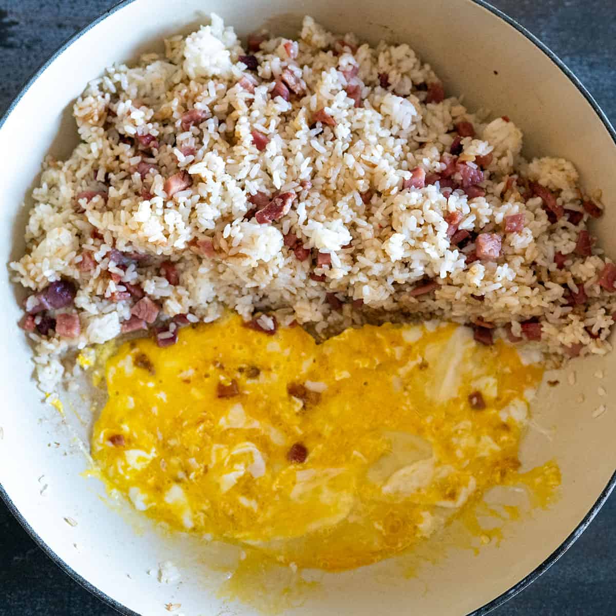 beaten egg added to skillet of ham and rice.