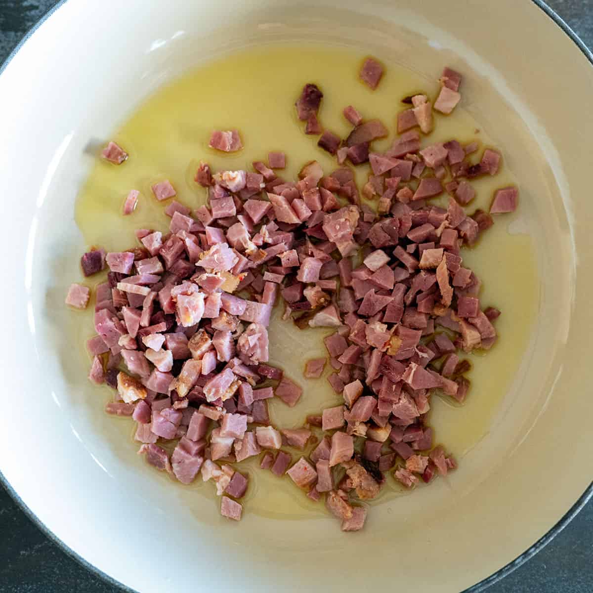Cooking diced ham in skillet.