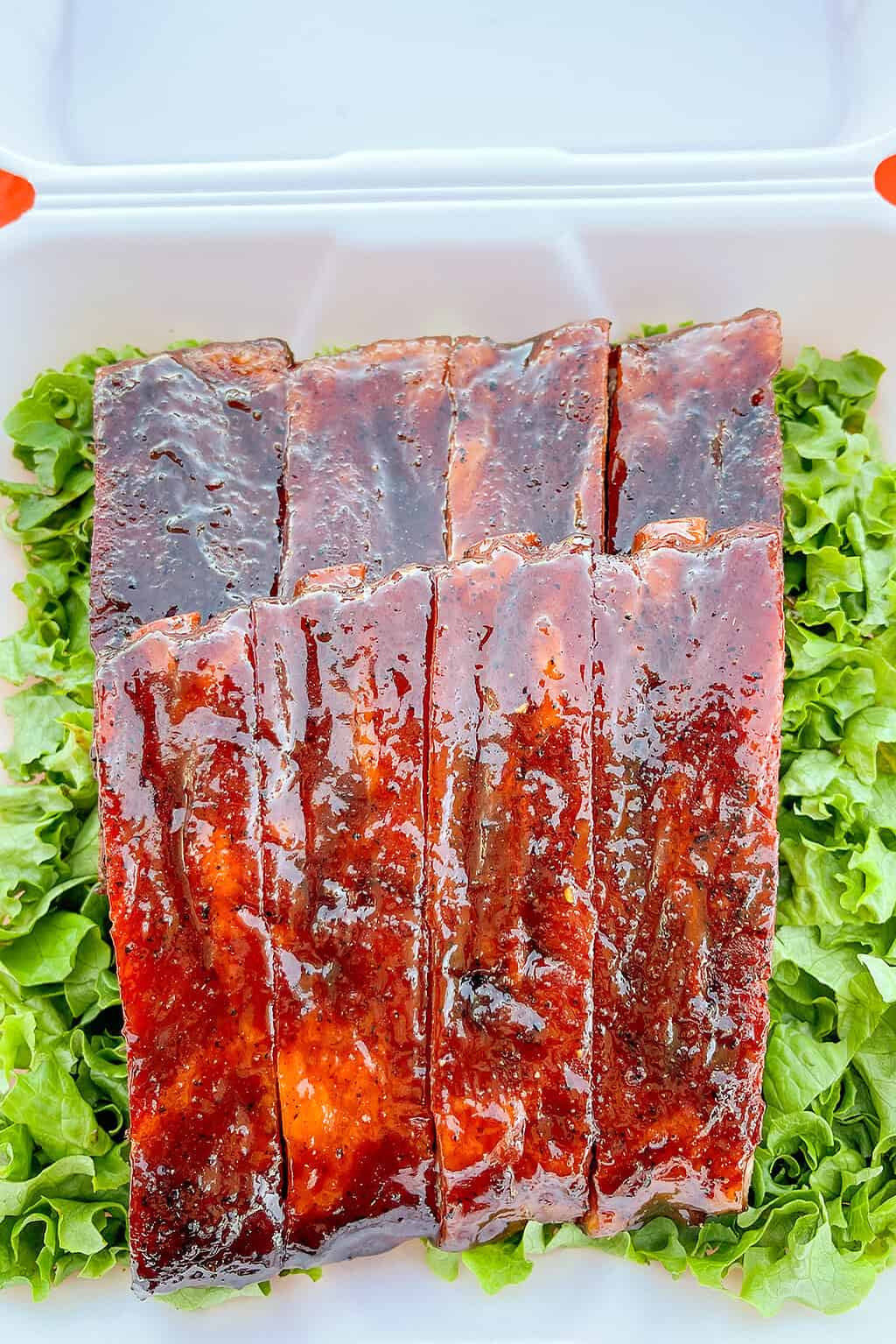 Hanging ribs on a drum smoker for competition BBQ - Girls Can Grill