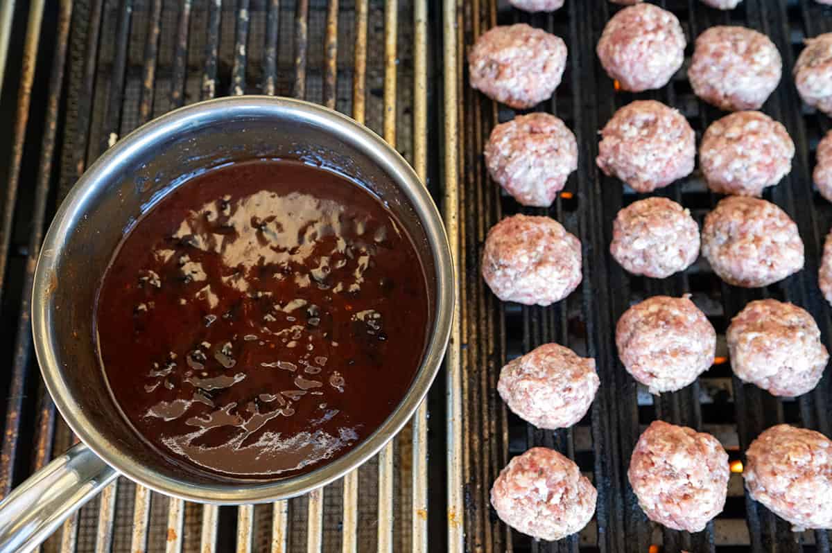 Meatballs and sauce pan on grill.