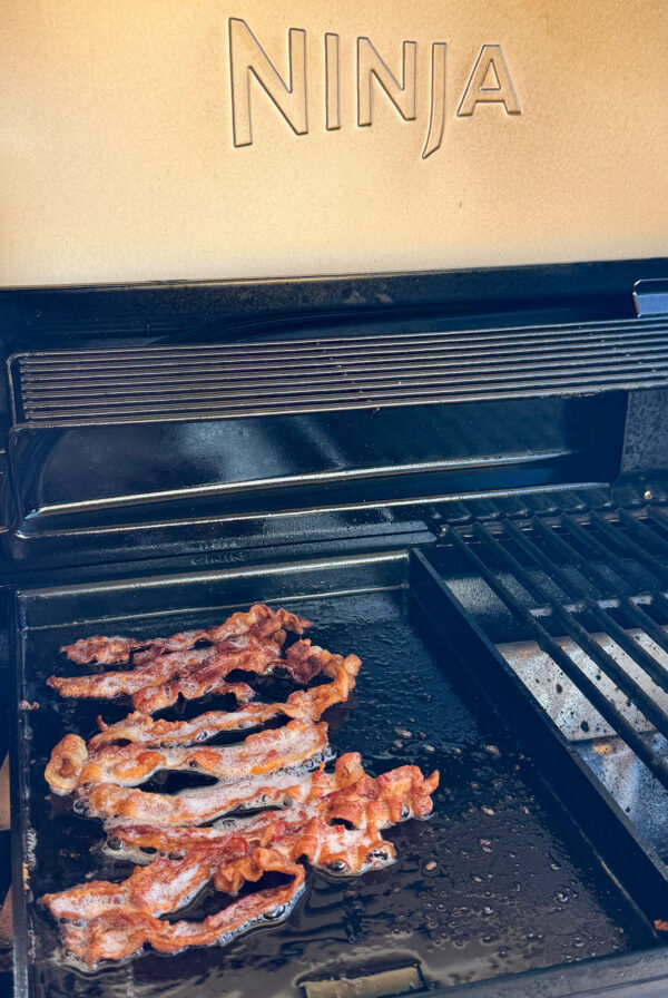 Ninja FlexFlame half griddle with bacon.