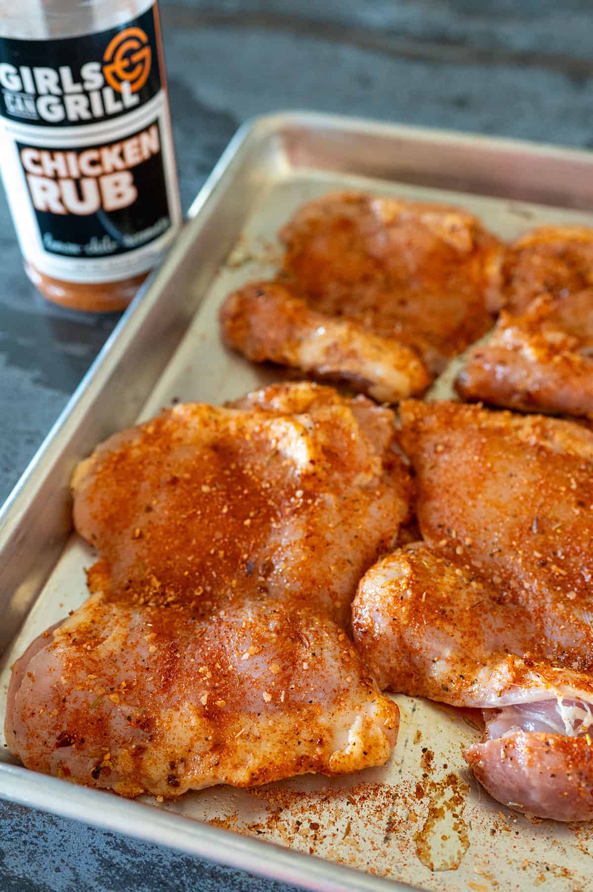 chicken thighs seasoned with Girls Can Grill Chicken Rub.