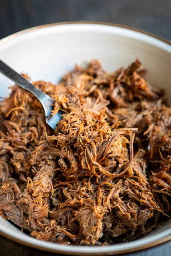 Fork full of shredded brisket.