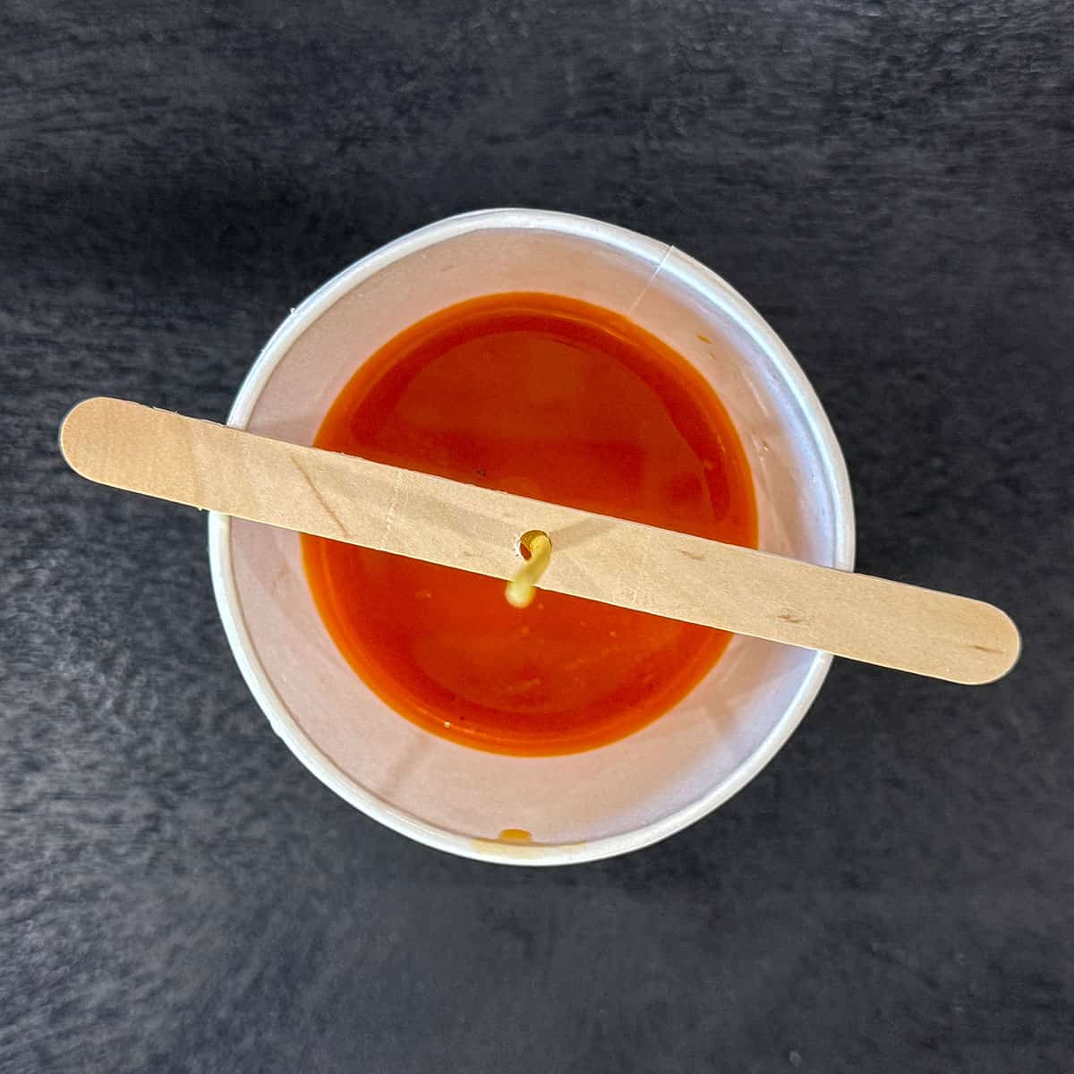 Herb butter in cup with wick.