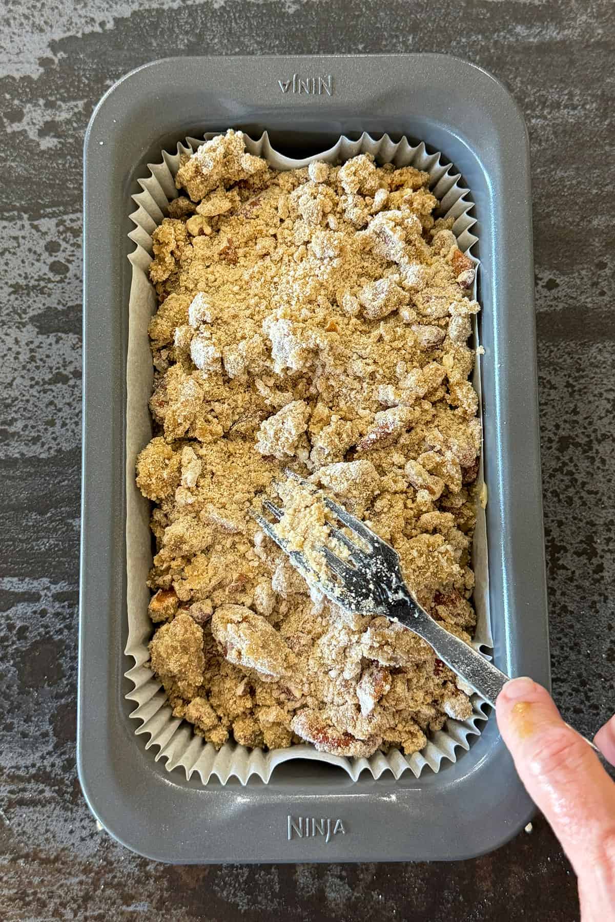 adding crumble to banana bread.