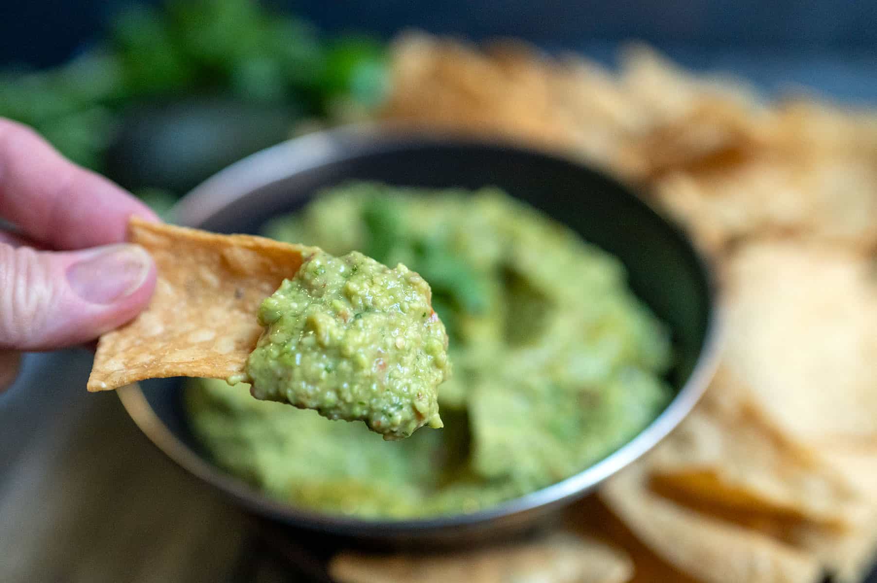 Dipping chip in Homemade Guacamole.