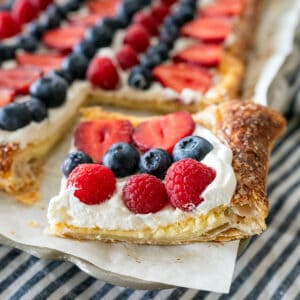 Slice of fruit pizza showing cheesecake layer.