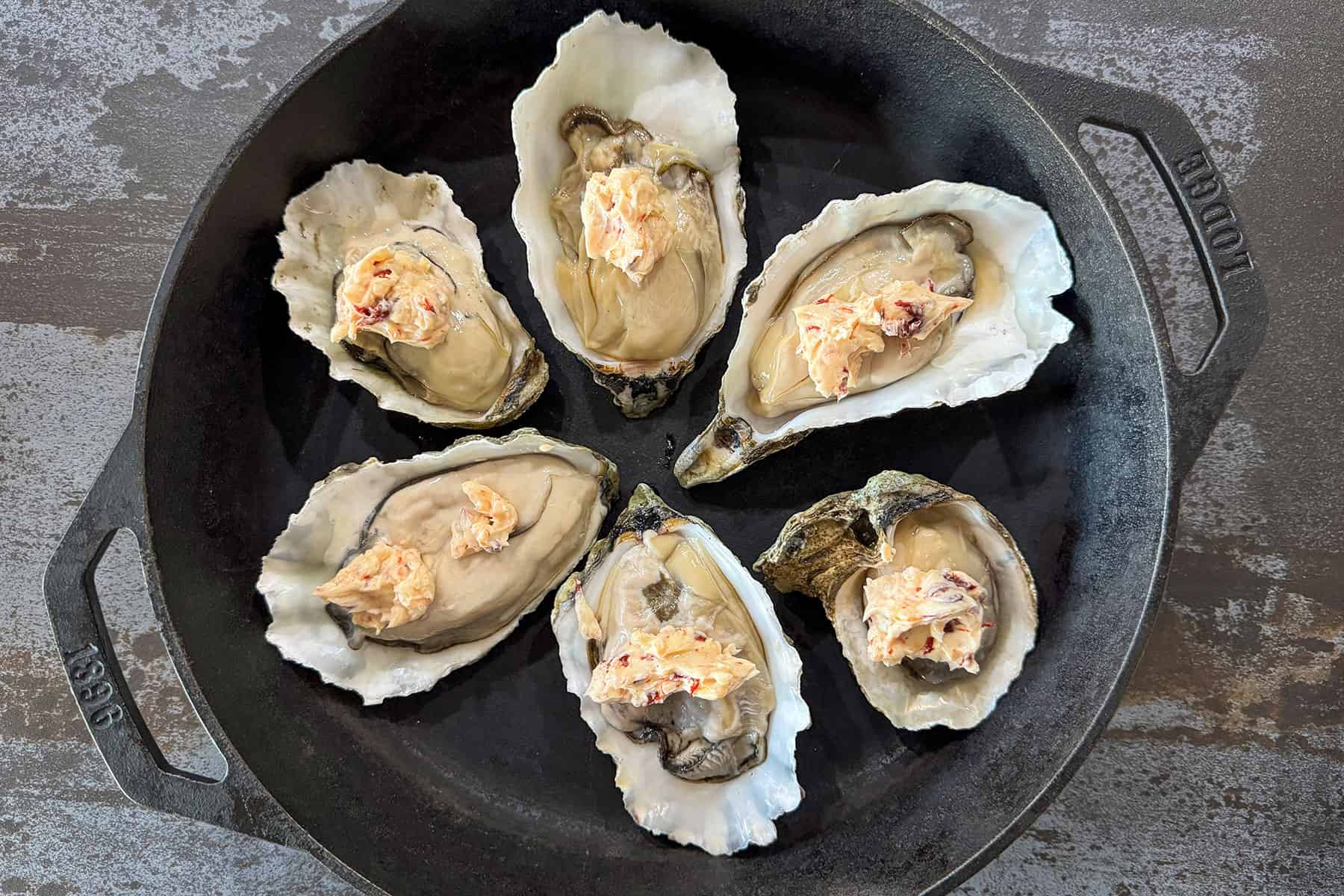 oysters topped with butter.