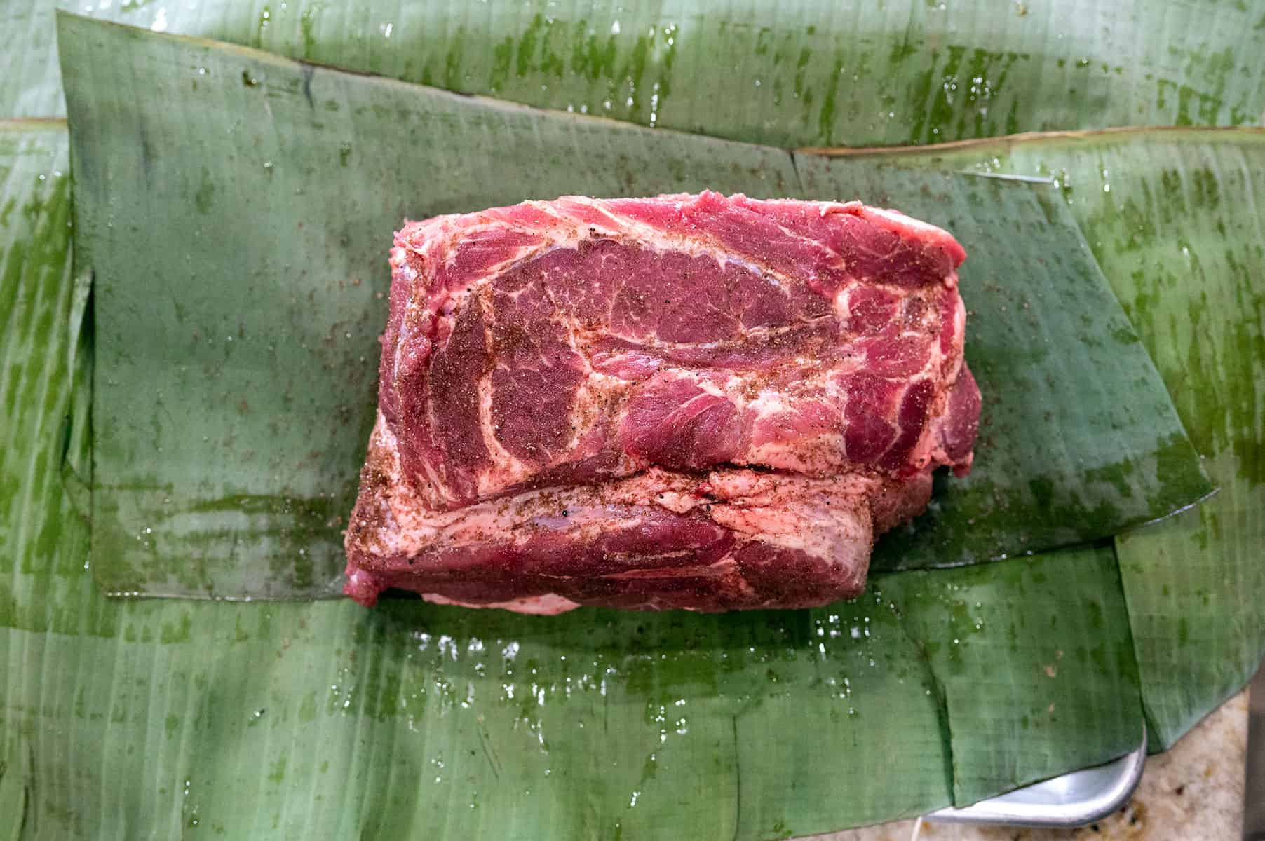 salted pork on banana leaves.