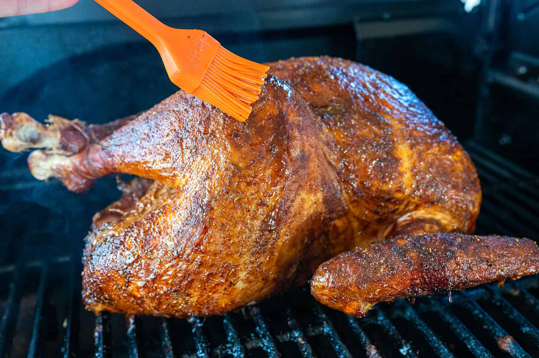 Basting a smoked turkey on the Ninja FlexFlame.