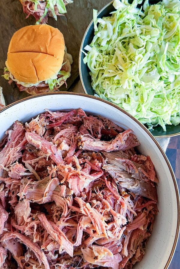 bowl of Pastrami Pulled Pork with slaw and sandwiches.