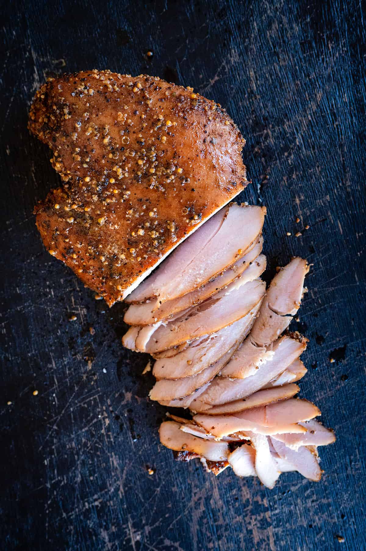 Sliced smoked turkey pastrami breast.