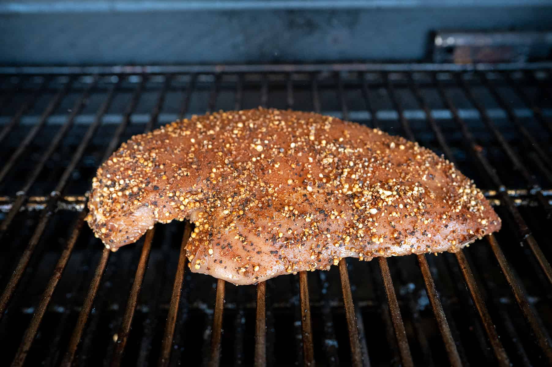 seasoned turkey breast on smoker.