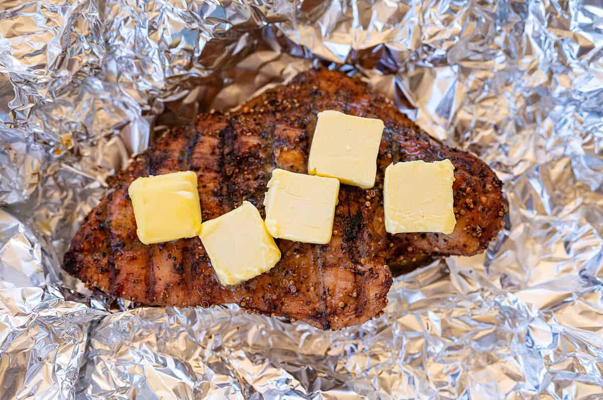 pastrami turkey breast on foil with butter.