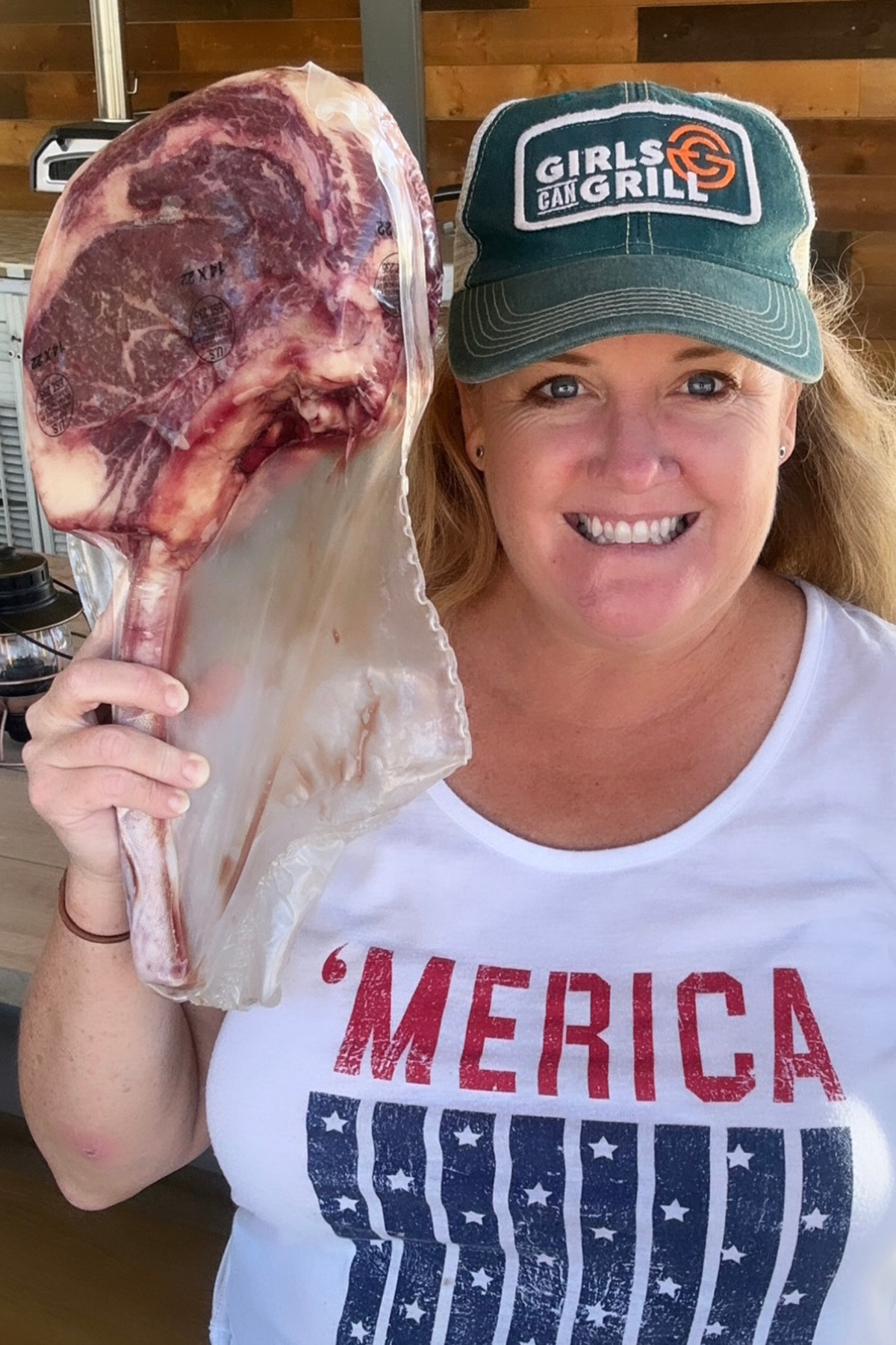 Christie Vanover holding a raw steak.