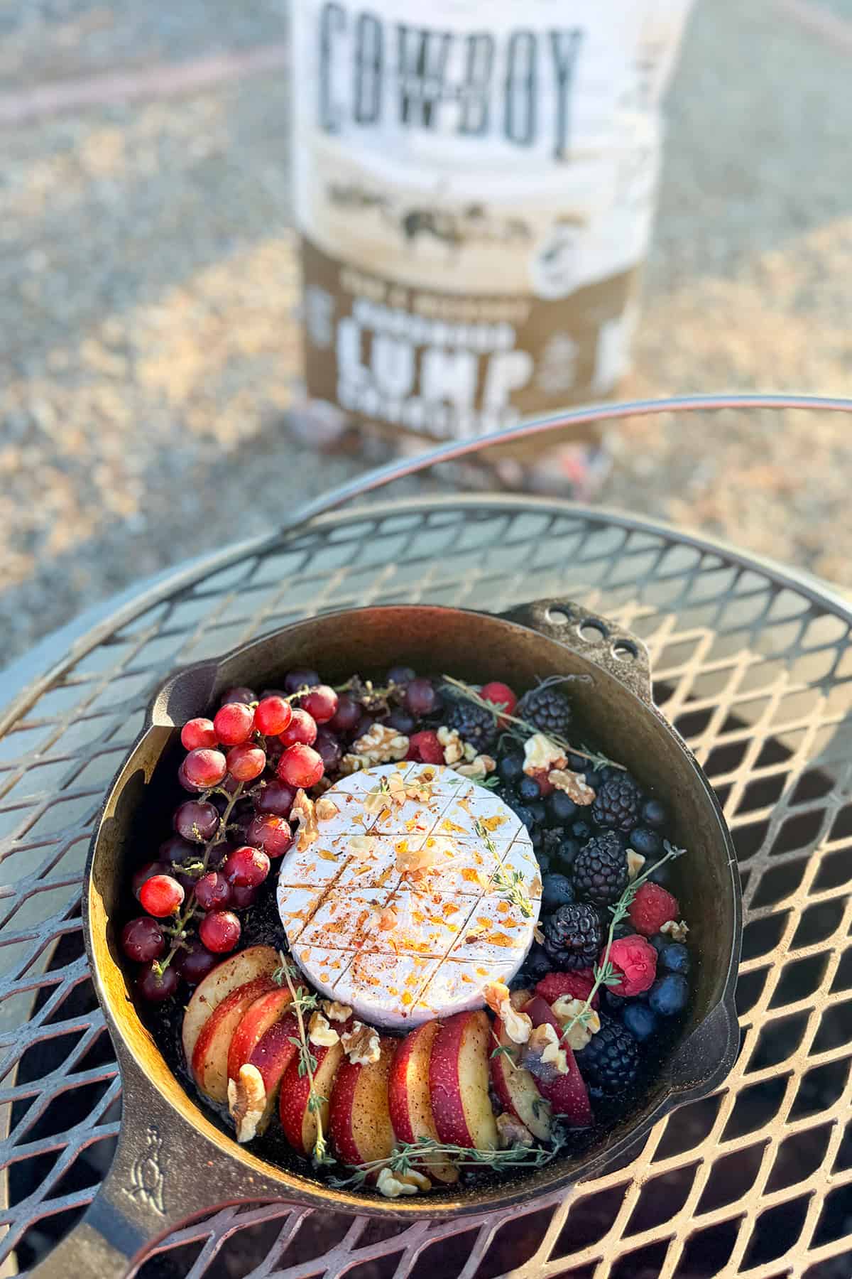 Brie dip in a skillet on a campfire.