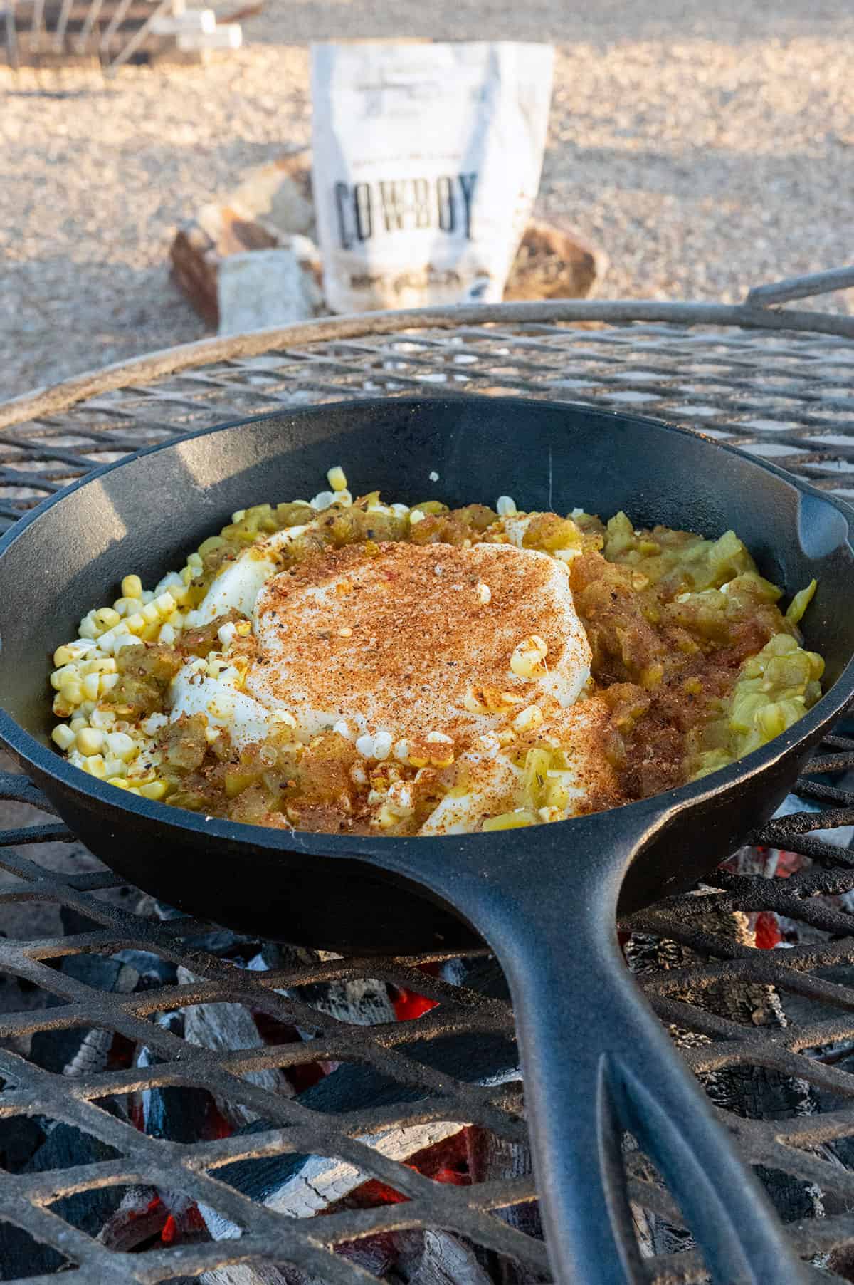 Oaxaca cheese in skillet surrounded by corn and hatch chile.