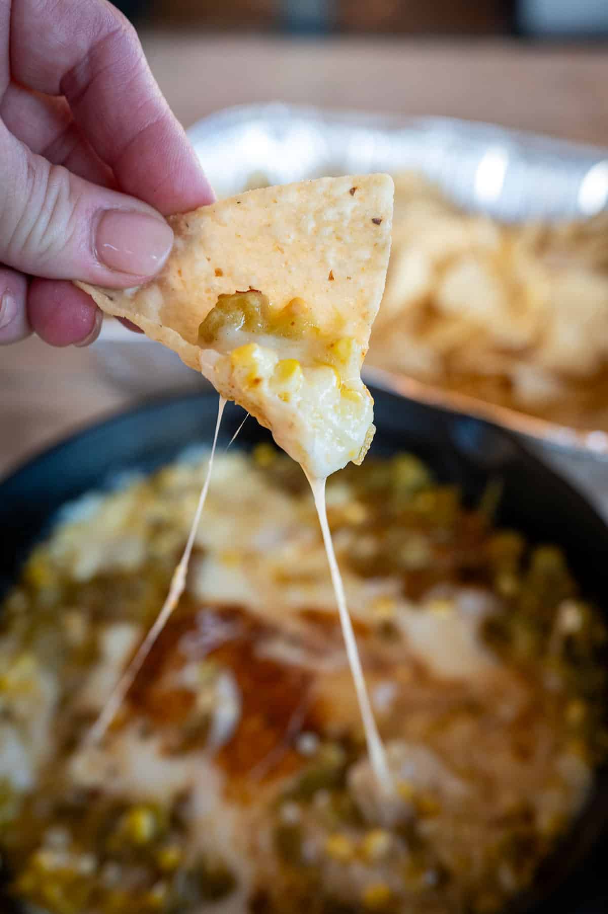 Tortilla chip with Hatch Chile Oaxaca Cheese Dip.